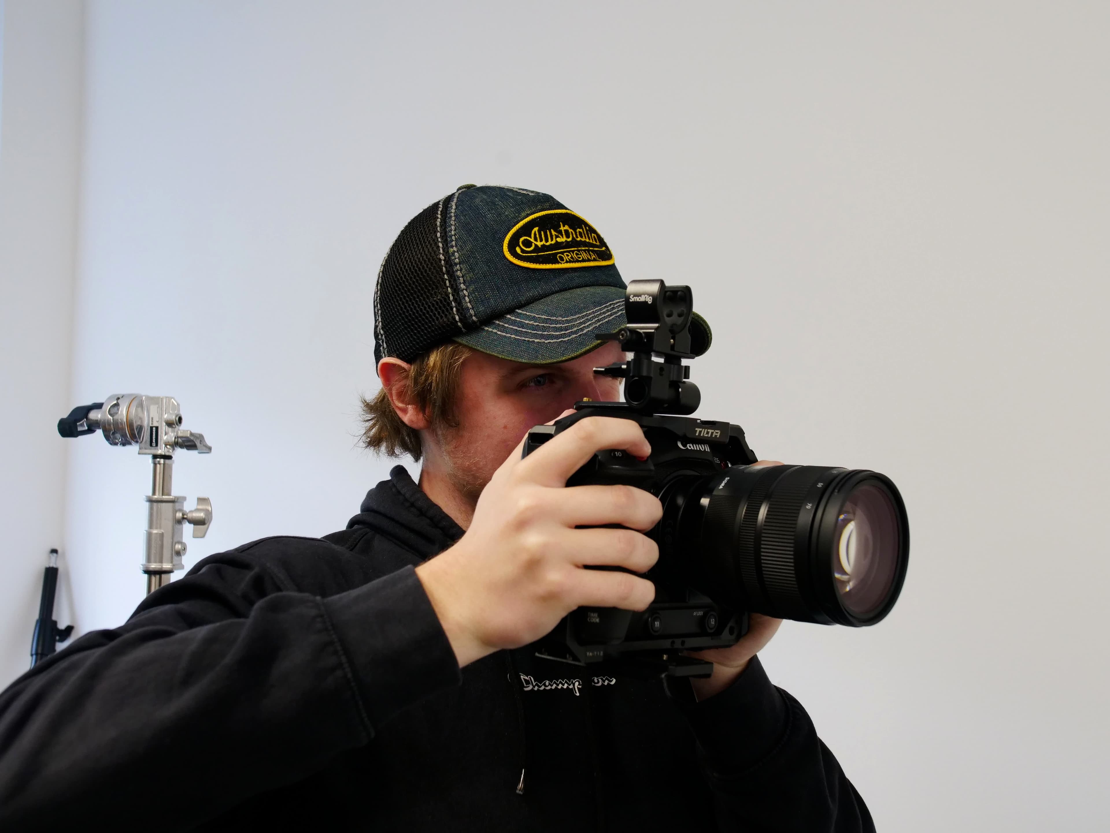 Josiah with professional camera equipment at Vault 5 Digital